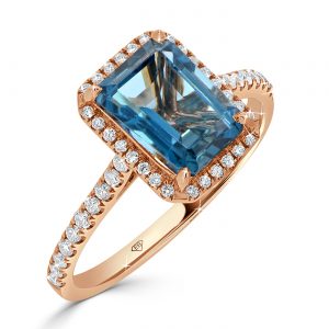 Rose gold emerald cut London Blue topaz with round diamond halo