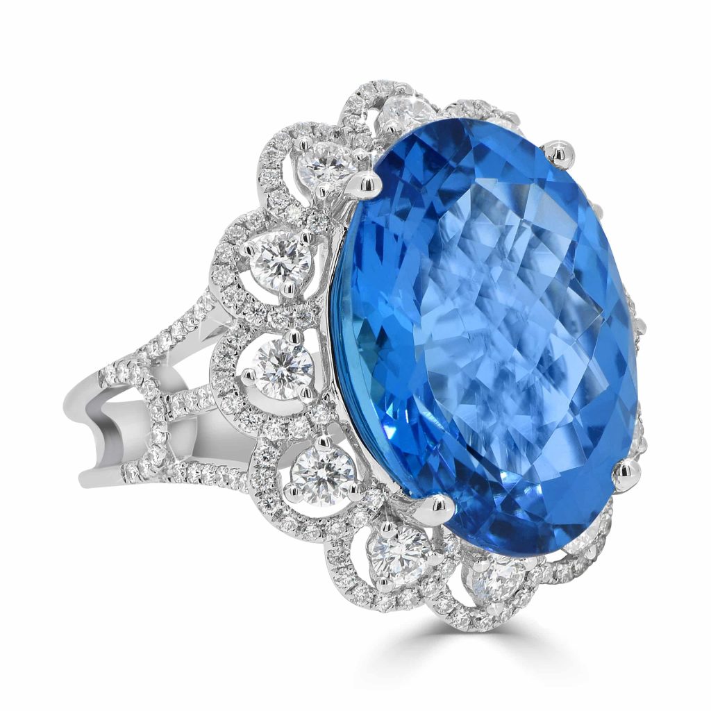 Oval Blue Topaz Diamond Dress Ring with a Halo and Flower Like Band